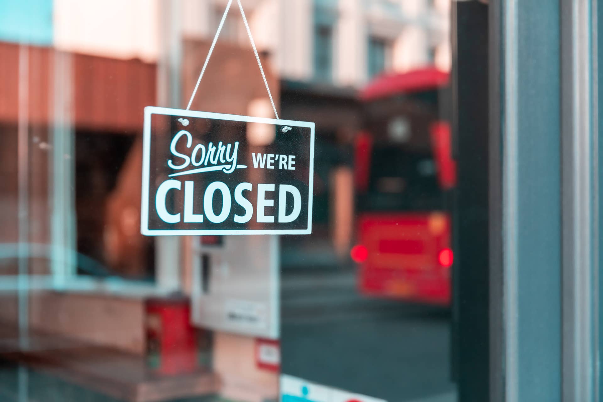 Sorry we're closed sign at shop entrance