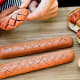 SlotdogThis device cuts a grid into hot dogs and sausages so they look great, cook quicker and create crispy caramelized-edged squares which grab hold of your toppings. Works best on thin-skinned or skinless hot dogs. They sell them at Ace Hardware and online for around $17.Photo: Slotdog