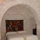 As with most traditional trulli, the beds/bedrooms are placed in arched alcoves carved into the walls. Sometimes curtains are hung in front of the bed for privacy. PHOTO CREDIT: Viviun