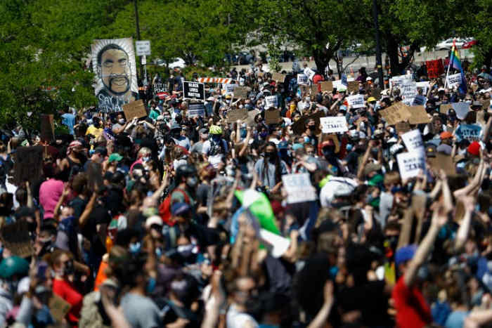 People gather for a rally in Minneapolis following the death of George Floyd. George Soros has long been a target of conspiracy theories and is now being falsely accused of orchestrating and funding the protests over police killings of Black people that have roiled the United States. (AP Photo/Julio Cortez)