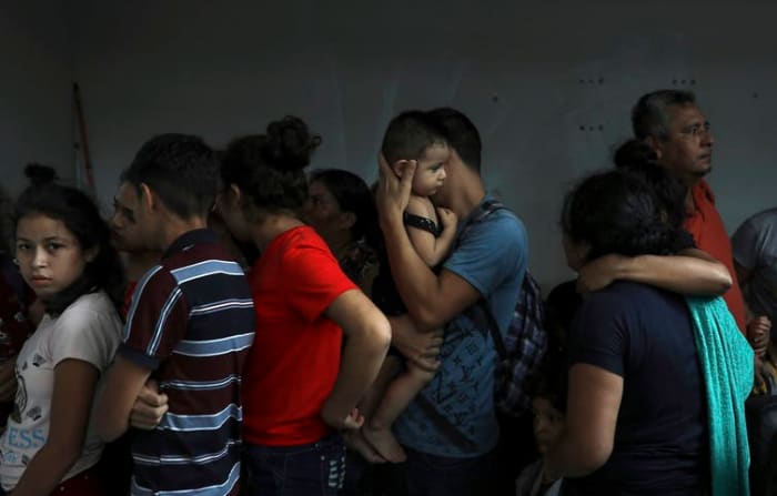 Detained migrants huddle together in a storage room at the back of a hotel where they tried to hide from Mexican immigration agents conducting a raid, in Veracruz, Mexico, in June 2019. Under increasing U.S. pressure to reduce the flow of Central Americans through Mexican territory, Mexico stepped up enforcement. (AP Photo/Felix Marquez)