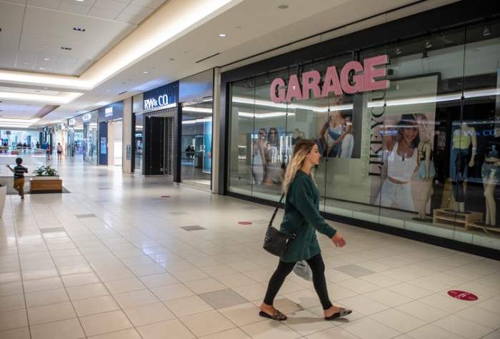 A shopper walks in the relatively empty Bayshore Shopping Centre mall in Ottawa on its first day open as part of Stage 2 of Ontario’s plan to lift COVID-19 lockdowns. THE CANADIAN PRESS/Justin Tang