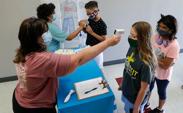 Temperature checks are one form of screening, but miss many COVID-19 cases since 40% of infected people are asymptomatic. AP Photo/LM Otero, File