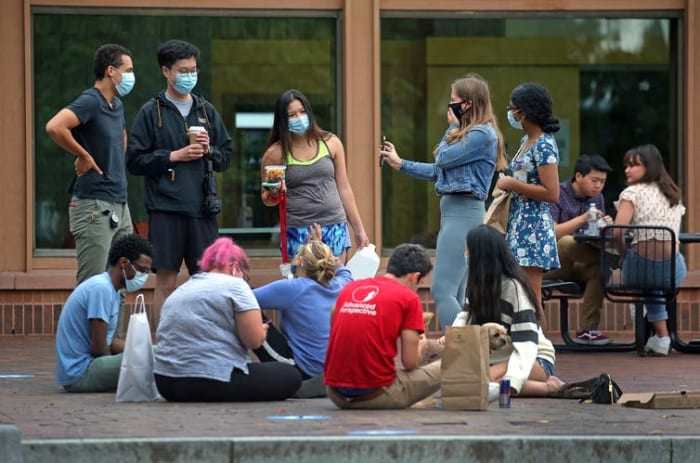 College campuses bring a lot of people together in close proximity, increasing the risk of getting and spreading COVID-19. David L. Ryan/The Boston Globe via Getty Images