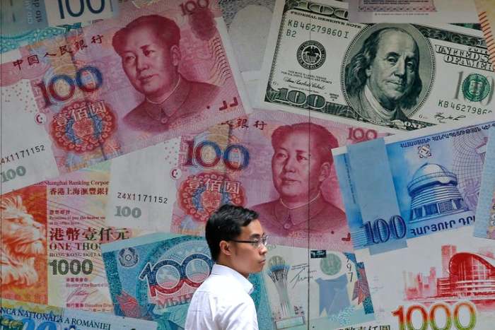 A money exchange shop decorated with different banknotes in a business district of Hong Kong. AP Photo/Kin Cheung, File