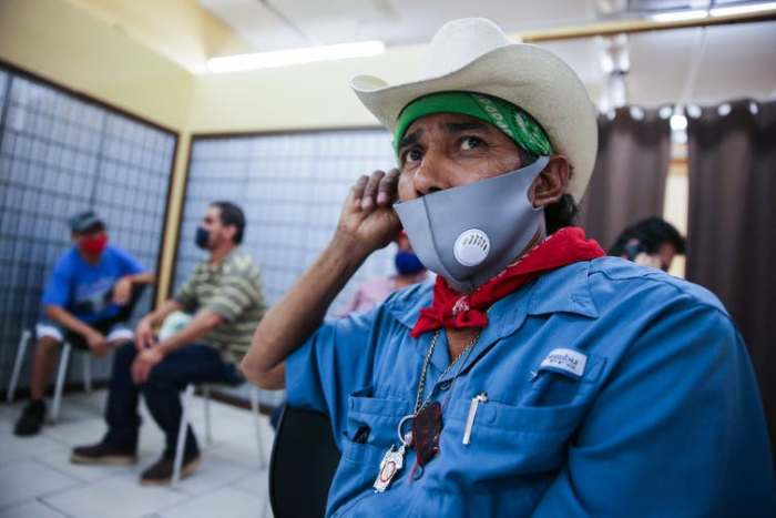 Unemployed workers wait to fill out job applications in a region hit hard by the COVID-19 pandemic. Mario Tama/Getty Images