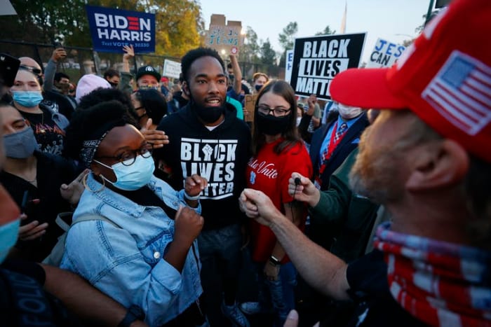 Biden and Trump supporters clash prior to the vice-presidential debate in Salt Lake City on October 7 2020. Jeff Swinger/AP