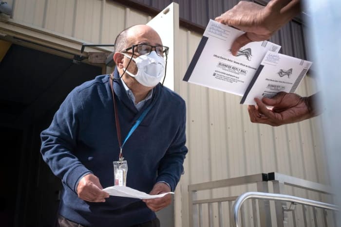 Election workers in Pennsylvania, like the one seen here, couldn’t begin verifying mail-in ballots until Election Day, meaning there may be significant delays before full results are available. AP Photo/Laurence Kesterson