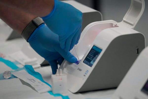 Rapid tests like the Abbott ID Now require only small, portable machines and can give results in 15 minutes, but they sacrifice accuracy. AP Photo/Jeff Chiu