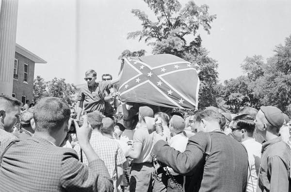 Rioting white students at University of Mississippi hoist a Confederate battle flag in a backlash against James Meredith’s attendance as the first Black student in 1962. Bettman via Getty Images
