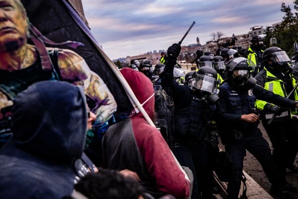 Police officers attempt to push back a pro-Trump mob trying to storm the U.S. Capitol following a rally with Trump on Jan. 6, 2021. Samuel Corum/Getty Images
