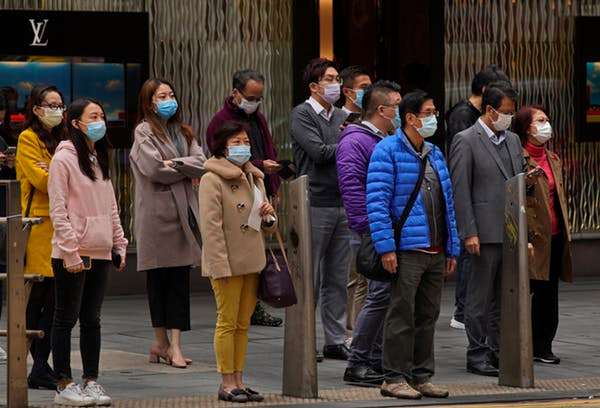 People in Hong Kong, concerned about coronavirus spreading from mainland China, wear face masks in February 2020. AP Photo/Vincent Yu