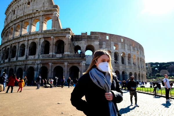 A tourist outside the Colosseo monument in downtown Rome. Italy has recorded the highest death toll. Andreas Solaro/AFP-GettyImages