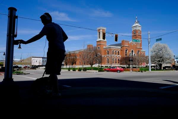 In Greensburg, Indiana, an empty town square, with only a teenager walking his dog. AP / Darron Cummings