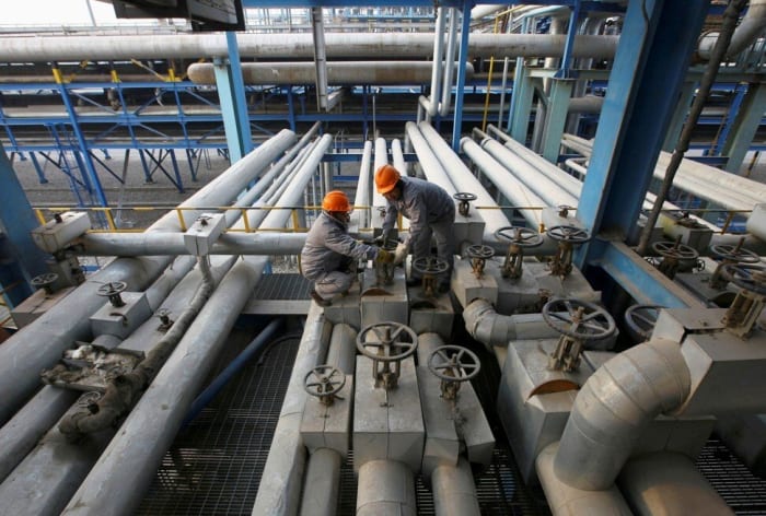 Employees closing a valve at a PetroChina refinery in Lanzhou in Gansu province on January 7, 2011. Photo: Reuters