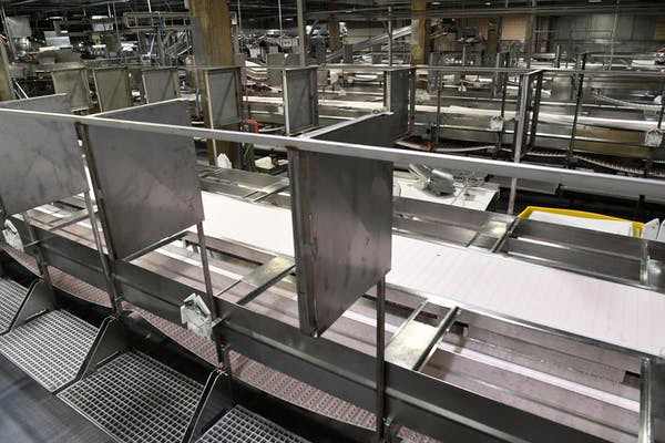 Meat processing stations at the JBS Beef Plant in Greeley, Colo., equipped with new sheet-metal partitions, April 23, 2020. As of early May 2020 the plant had recorded more than 200 confirmed cases of COVID-19 and 6 employee deaths. Andy Cross via Getty Images
