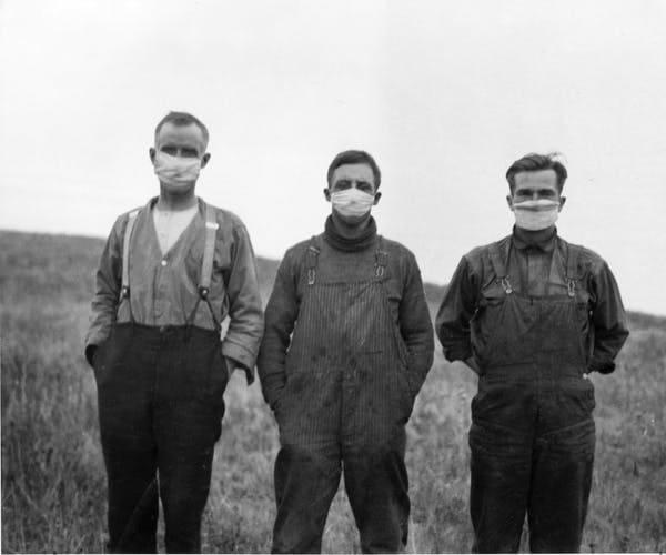 Men wear masks in Alberta during the influenza pandemic of 1918. Second and third waves of the flu added to economic woes in the early 20th century. THE CANADIAN PRESS/National Archives of Canada