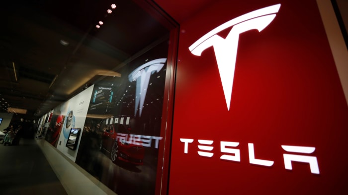 Figure 1: A sign bearing the company logo outside a Tesla store in Cherry Creek Mall in Denver.