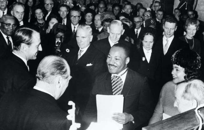 Crown Prince Harald and King Olav of Norway congratulate King after he receives the Nobel Peace Prize in Oslo in 1964. Bettmann