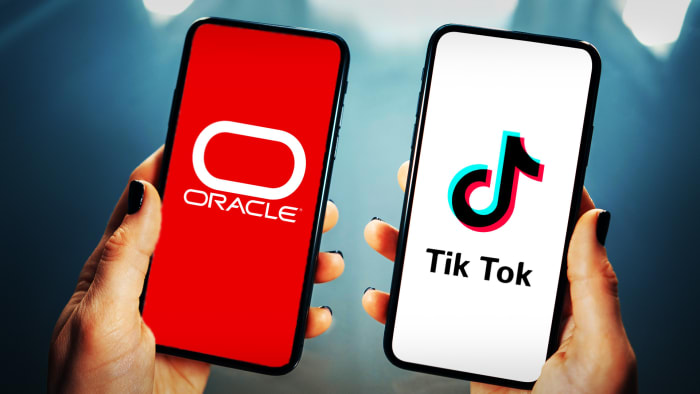 The Oracle and TikTok logos on smartphones. Lead JS.