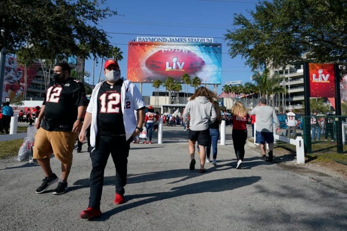 When football stadiums had more than 20,000 fans on hand, the surrounding communities saw a spike in COVID-19 cases within three weeks. AP Photo/Lynne Sladky