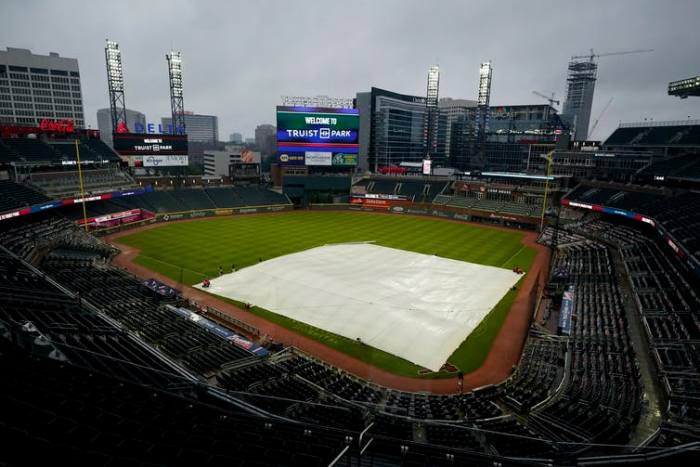 Coca-Cola and Delta, their corporate logos seen here overlooking Truist Park in Atlanta, are major employers in Georgia. AP Photo/John Bazemore
