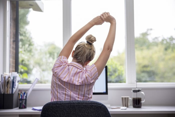 A woman works at a desk,