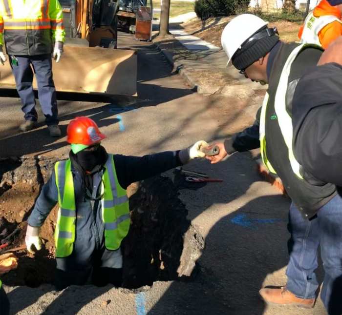 Workers remove water service lines in Trenton, New Jersey, on Jan. 9, 2020. The city is replacing 37,000 lead pipes over five years. AP Photo/Mike Catalini