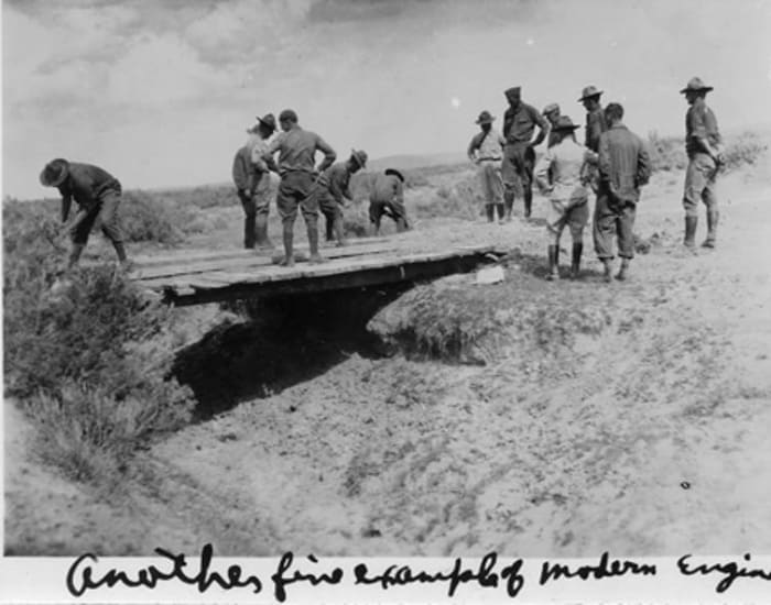 In a photo captioned ‘Another fine example of modern engineering,’ members of the 1919 Transcontinental Motor Convoy decide whether a rickety bridge will support their vehicles. Eisenhower Presidential Library
