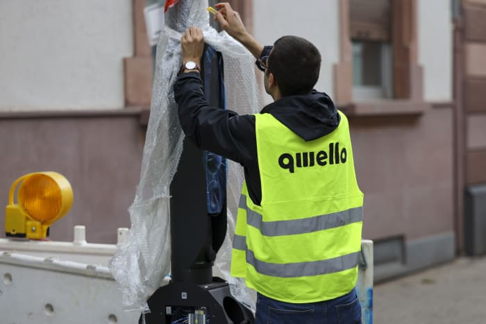 A technician removes bubble wrap during the installation of a street-side electric vehicle (EV) charging station, operated by Qwello GmbH, in Frankfurt, Germany, on Thursday, Sept. 15, 2022. The German government has said it wants 1 million public charging points by 2030, the majority of which it wants to be fast charging points. Photographer: Alex Kraus/Bloomberg via Getty Images