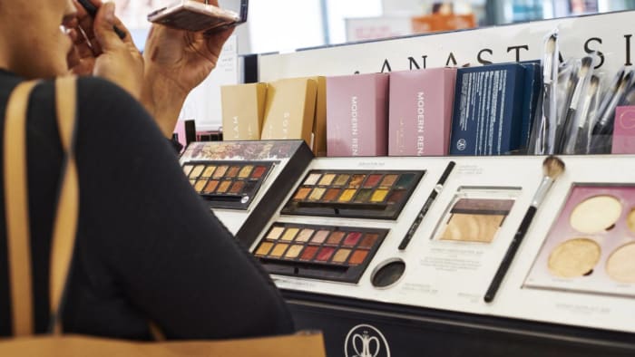 A customer applies makeup at an Ulta Beauty store. lead.