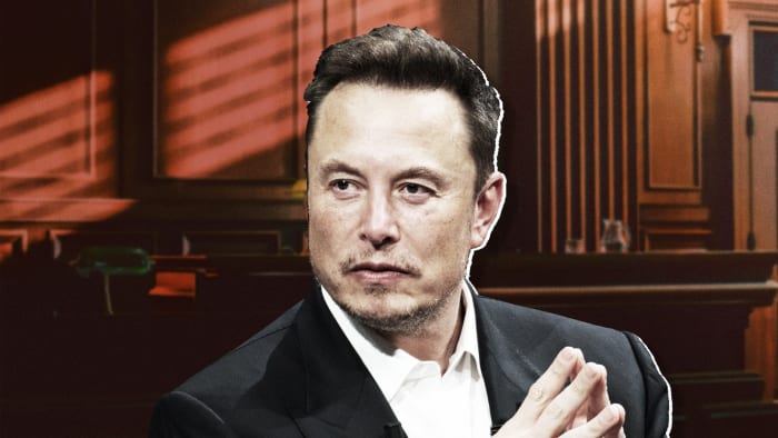 Elon Musk with his hands folded. .