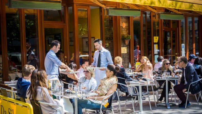 People are shown eating lunch at a New York City cafe. lead.