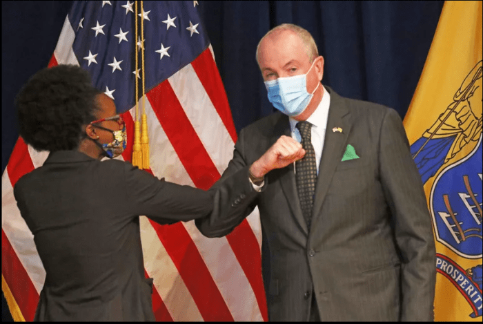 NJ Gov. Phil Murphy bumping elbows with the NJ Cannabis Regulatory Commission Chair Dianna Houenou