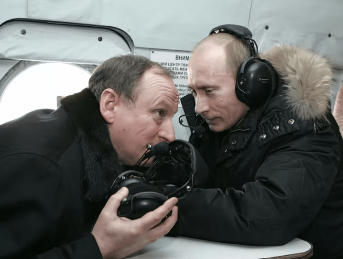 Russian President Vladimir Putin (right) and FSB chief Nikolai Patrushev fly on a helicopter to visit a military outpost on Feb. 4, 2008. Mikhail Klimentyev/AFP via Getty Images)