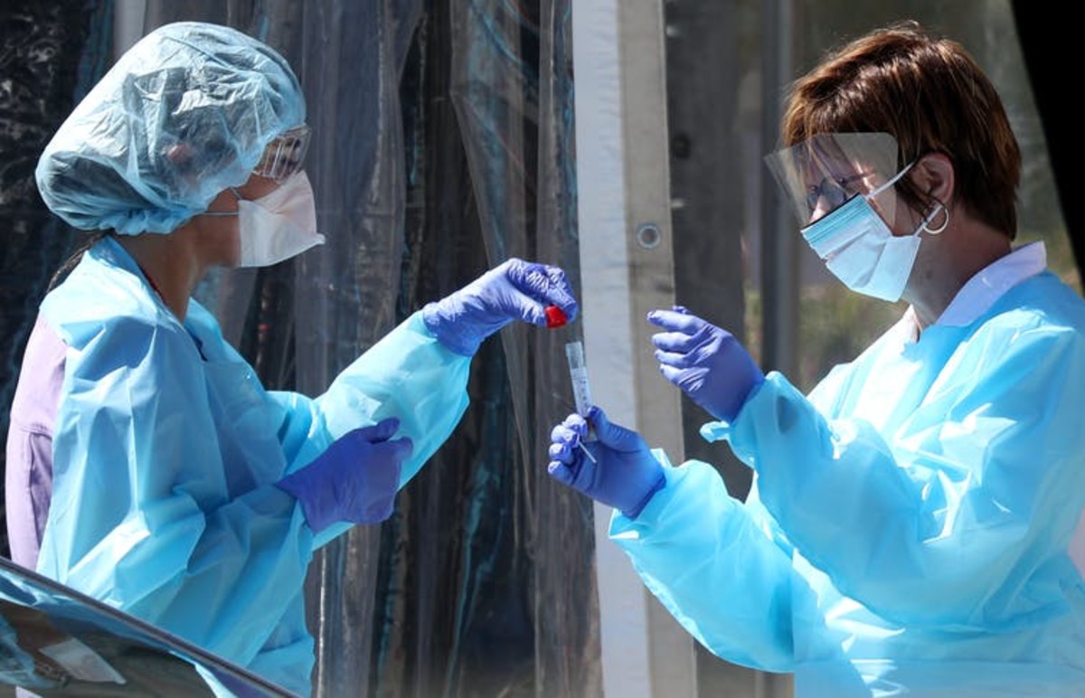 Medical personnel secure a sample from a person at a drive-through coronavirus COVID-19 testing station at a Kaiser Permanente facility on March 12, 2020 in San Francisco, Calif. Justin Sullivan/Getty Images