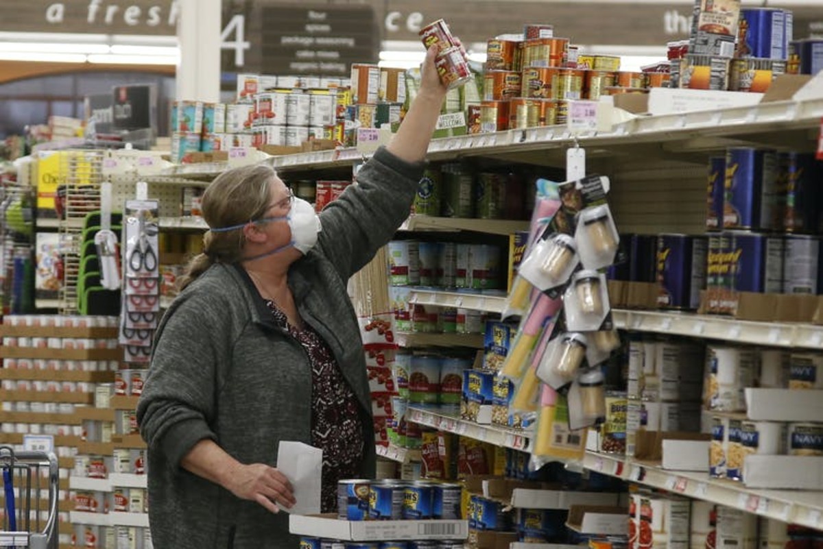 Grocery stores have been giving older and at-risk shoppers time to shop away from other people, but knowing whether the store employees are infected is not easy. AP Photo/Sue Ogrocki