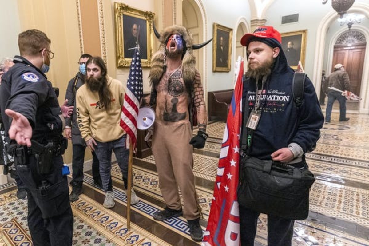A shirtless man known as the ‘QAnon Shaman’ was one of the high-profile members of Trump supporters who invaded the U.S. Capitol. (AP Photo/Manuel Balce Ceneta)