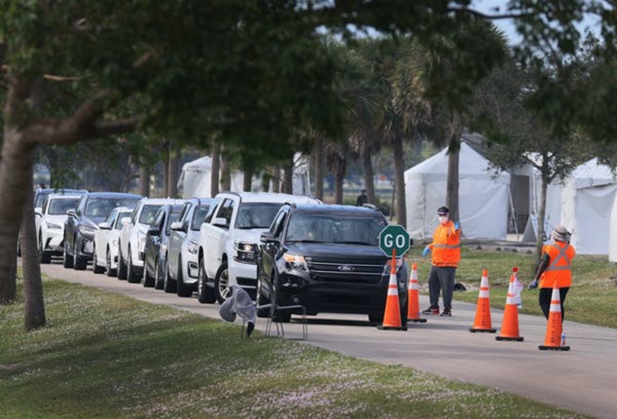 In Davie, Fla., Department of Health workers direct cars at a drive-thru vaccination site. Joe Raedle via Getty Images