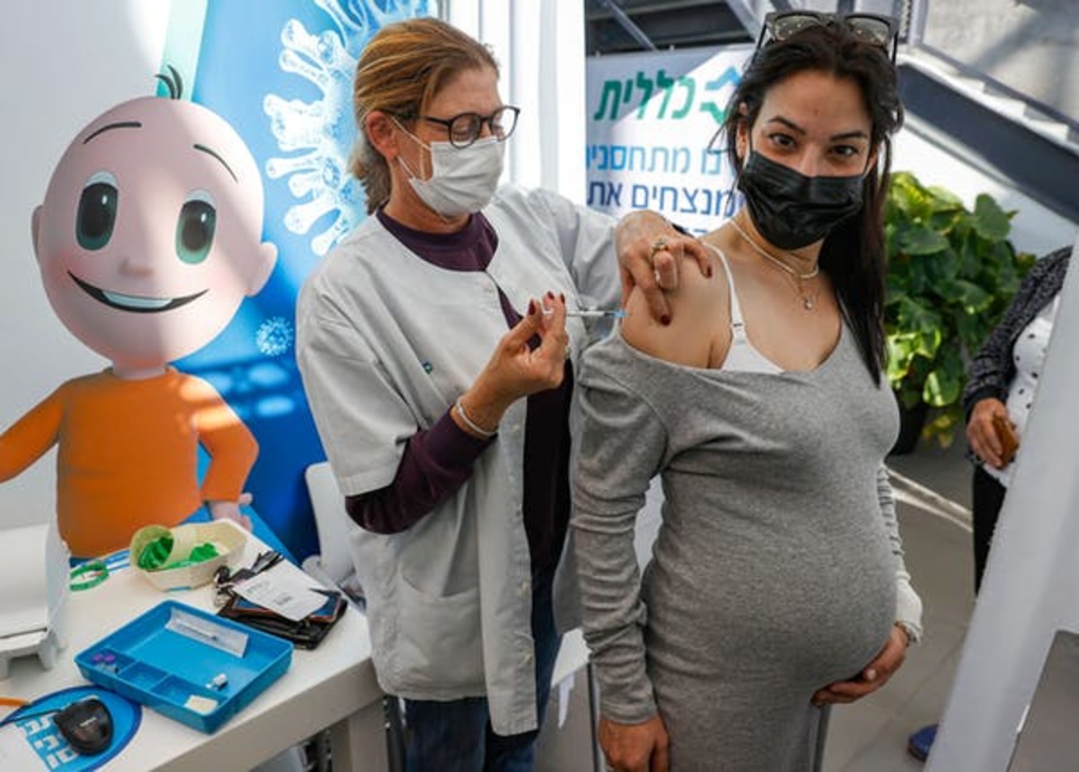 A health worker administers a dose of the Pfizer-BioNtech COVID-19 vaccine to a pregnant woman in Israel on Jan. 23. Jack Guez/AFP via Getty Images