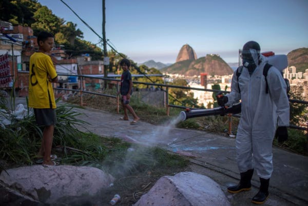 A volunteer disinfects Rio’s Santa Marta favela, Brazil, April 2020. Mauro Pimintel/AFP via Getty Images