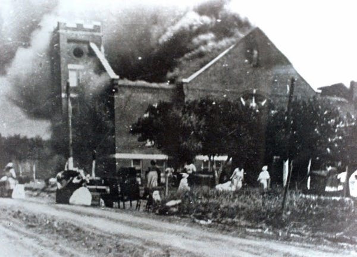 In this 1921 file image provided by the Greenwood Cultural Center, Mt. Zion Baptist Church burns after being torched by white mobs during the 1921 Tulsa massacre. (Greenwood Cultural Center via Tulsa World via AP)