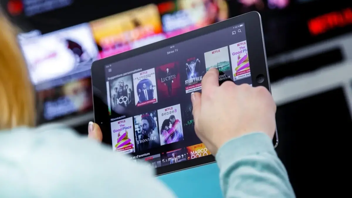 Figure 1: A person choosing content in the Netflix app on the iPad.