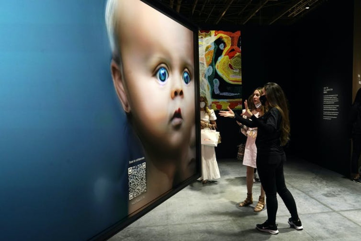 Nonfungible tokens (NFTs) use the cryptography of blockchain to make provably unique instances of digital items, including artwork like these images shown at an exhibition in Miami Beach in November 2021. AP Photo/Lynne Sladky