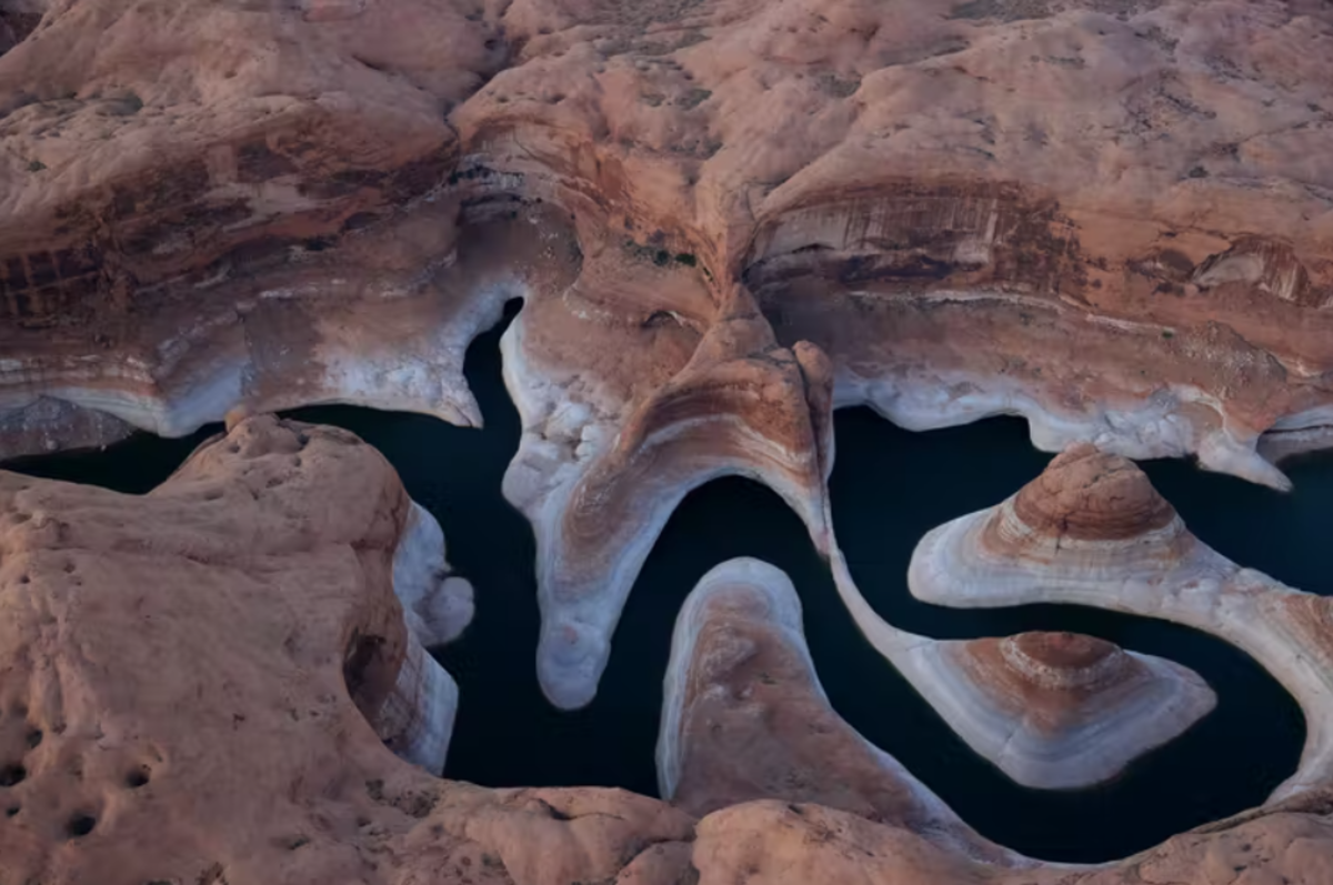 The ‘bathtub ring’ on Lake Powell, one of the nation’s largest reservoirs, attests to its falling water level over two decades of drought in Arizona. The Colorado River reservoir is crucial for water supplies and hydropower. Justin Sullivan/Getty Images