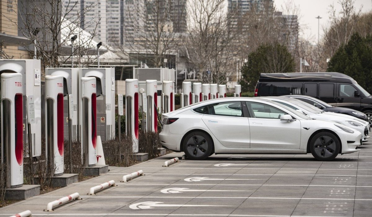 tesla electric vehicles are parked next to charging stations outside one of the companys showrooms in beijing photo bloomberg