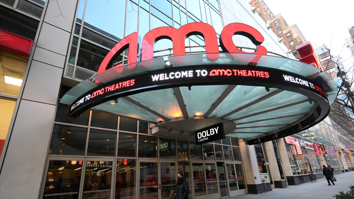 Figure 1: A pedestrian walks by the newly reopened AMC 34th Street theater on March 5, 2021, in New York.