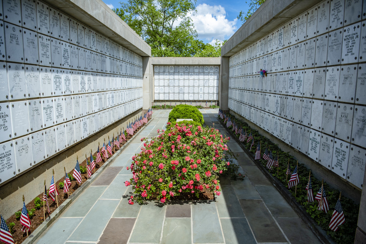 A view down a row at a columbarium with flowers in the middle