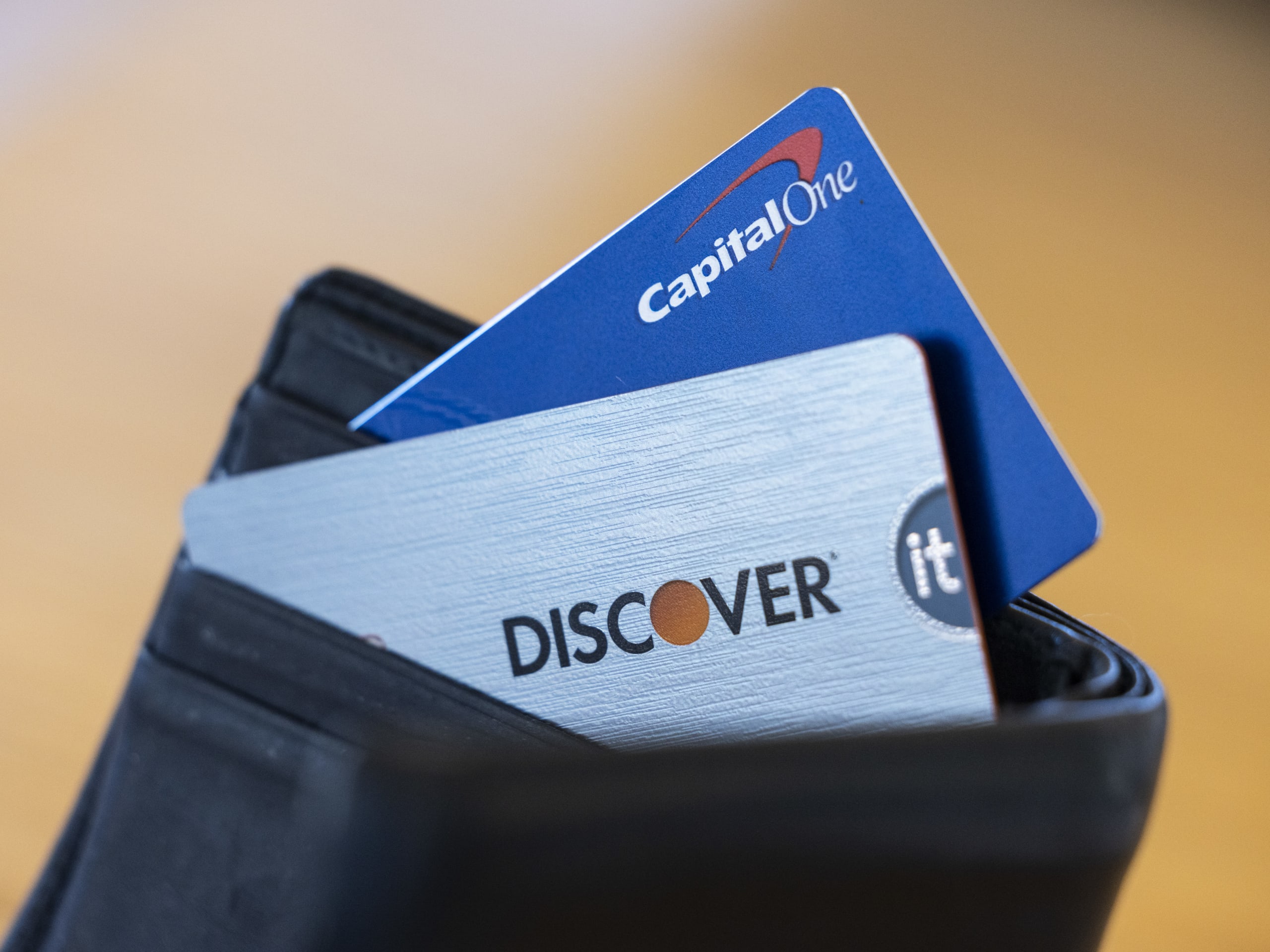 Capital One and Discover credit cards arranged in Germantown, New York, US, on Tuesday, Feb. 20, 2024. Capital One Financial Corp. agreed to buy Discover Financial Services in a $35 billion all-stock deal to create the largest US credit card company by loan volume, giving the combined entity a stronger foothold to compete with Wall Streets behemoths. Photographer: Angus Mordant/Bloomberg via Getty Images