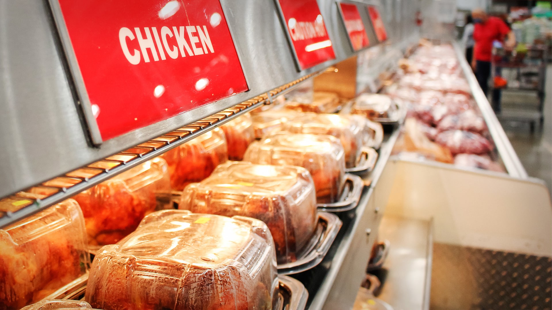 A shelf is full of Costco's rotisserie chickens.
